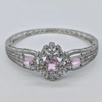 Silver ring with pink gemstones on a light gray background