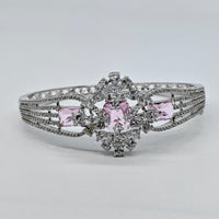 Silver bracelet with pink gemstones on a light gray background
