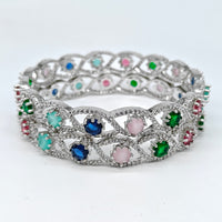 Silver ring with multicolored gemstones on a white background