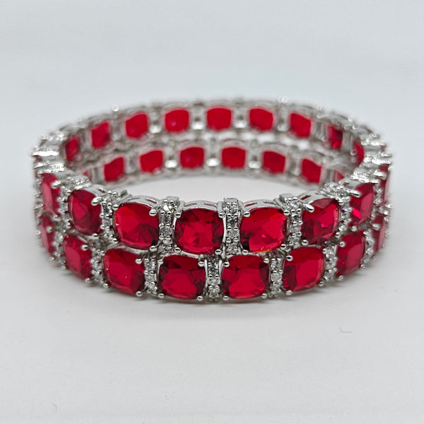 Red gemstone bracelet with silver accents on a white background