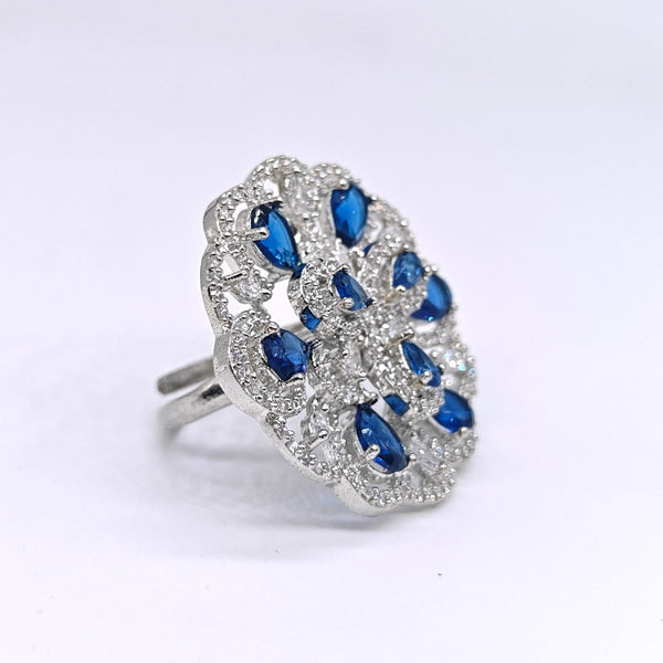 Silver ring with blue gemstones on a white background