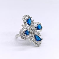 Silver ring with blue gemstones on a white background