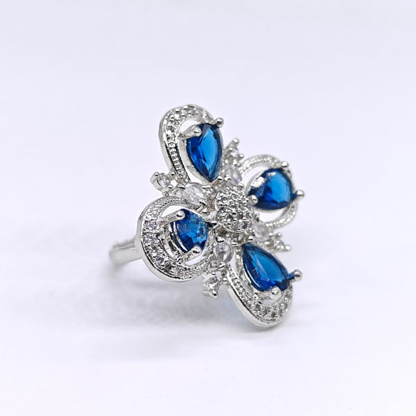 Silver ring with blue gemstones on a white background