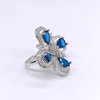 Silver ring with blue gemstones on a white background