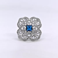 Silver-plated sapphire fleur adjustable ring with blue princess-cut center stone and sparkling American diamond floral design for women