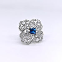 Silver ring with a blue gemstone on a white background