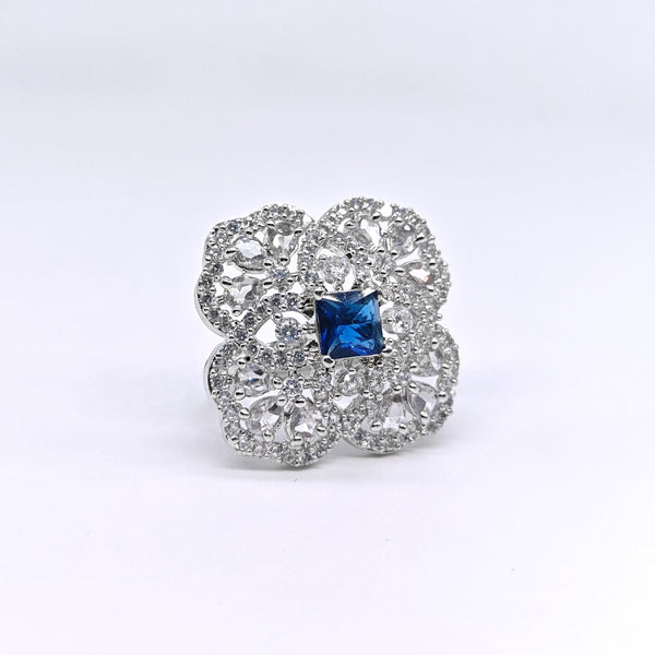 Silver ring with a blue gemstone on a white background