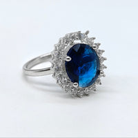 Silver-plated sapphire halo adjustable ring with blue oval stone and sparkling American diamond accents for women