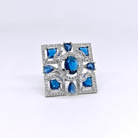 Silver ring with blue gemstones on a white background