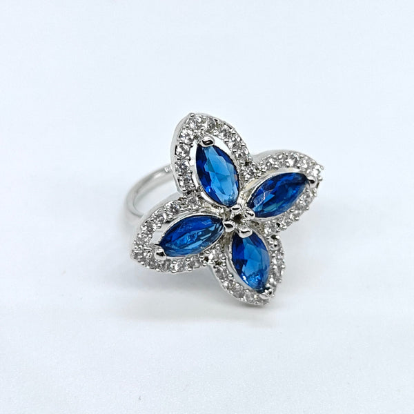 Butterfly-shaped ring with blue gemstones on a white background