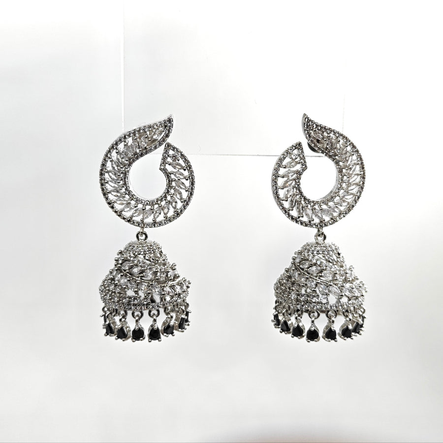 Pair of silver earrings with intricate designs on a white background