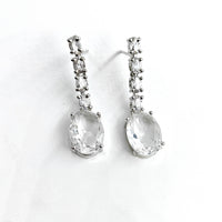 Pair of silver teardrop earrings on a white background