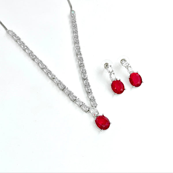 Jewelry set with red gemstones and silver accents on a white background