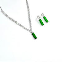 Green gemstone necklace and earrings on a white background